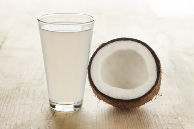 Coconut with a glass of coconut water